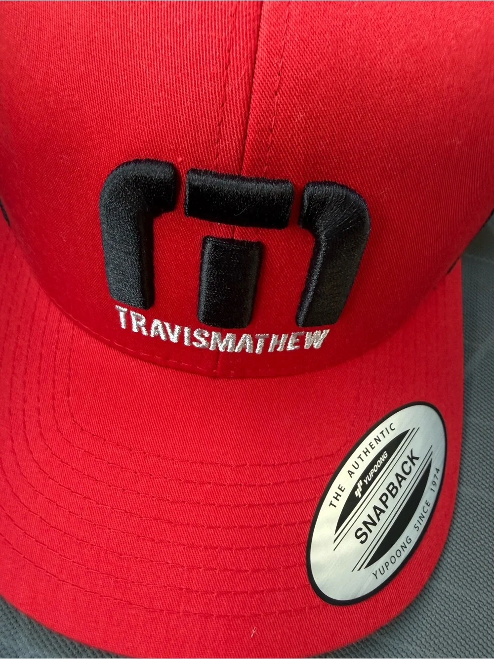 Travis Mathew Red and Black Curved Brim Hat